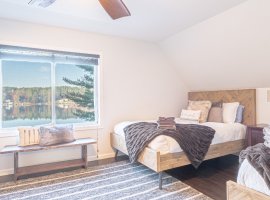 The third-level bedroom features 3 queen beds. Stunning lake views!