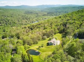 Aerial view of Hunter House's 20 private acres in the Catskills, featuring the spring-fed swimming p